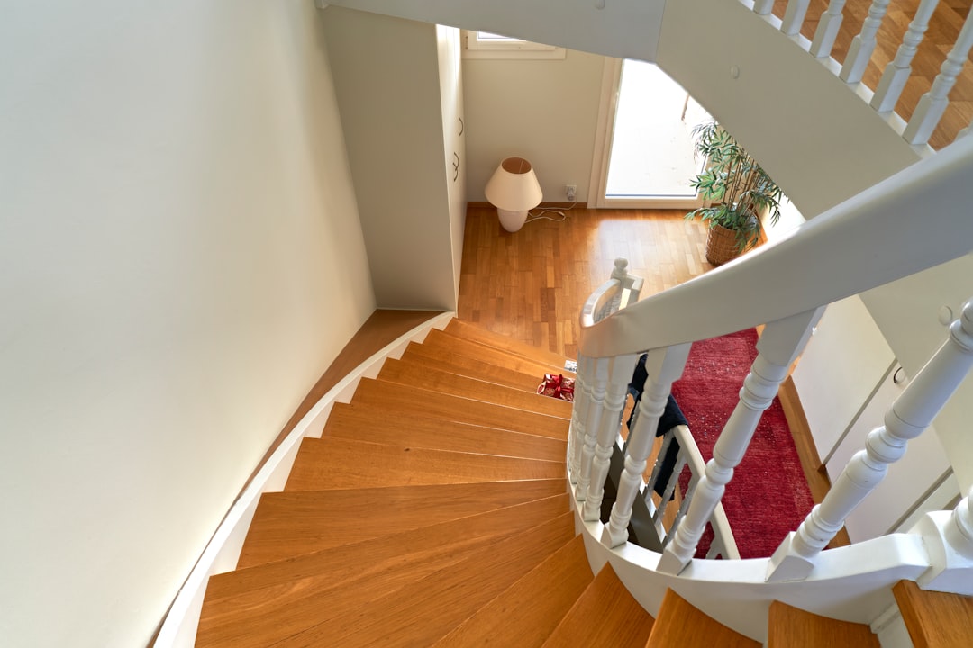 A close-up view of an elegant, modern floating staircase, highlighting the clean lines and quality craftsmanship within a luxury home.