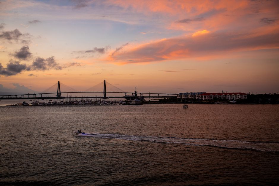 The scenic and charming riverwalk in downtown Wilmington, North Carolina, with its historic buildings and waterfront promenade, showcasing the city's unique lifestyle appeal.