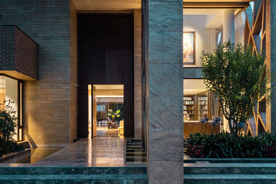 Close-up, minimalist shot of an architectural detail, like a floating staircase or custom woodwork, in a bright, modern lu...